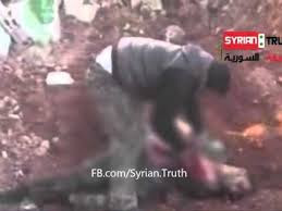 Video Of Syrian Rebel Leader Hacking A Dead Soilder's Body And Eating His Heart And Other Organs 1