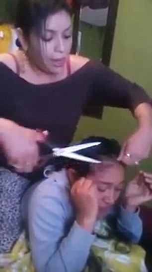 Woman Holds Down Her Boyfriend's Sidechick On A Bed, While Slapping And Cutting Off All Her Hair [VIDEO] 1