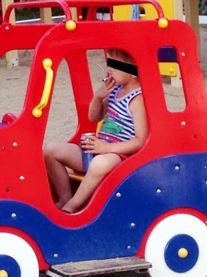 Shocking photos show 5yr old boy smoking & drinking can of beer in playground 24