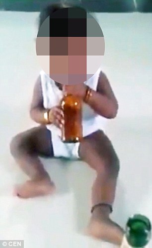 Shocking moment father laughs as he forces his 10-month-old baby to drink BEER in India [VIDEO] 2
