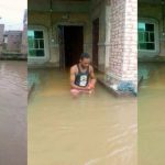 Nigerian Man Finds Humor In Bathing And Swimming In His Flooded House 12